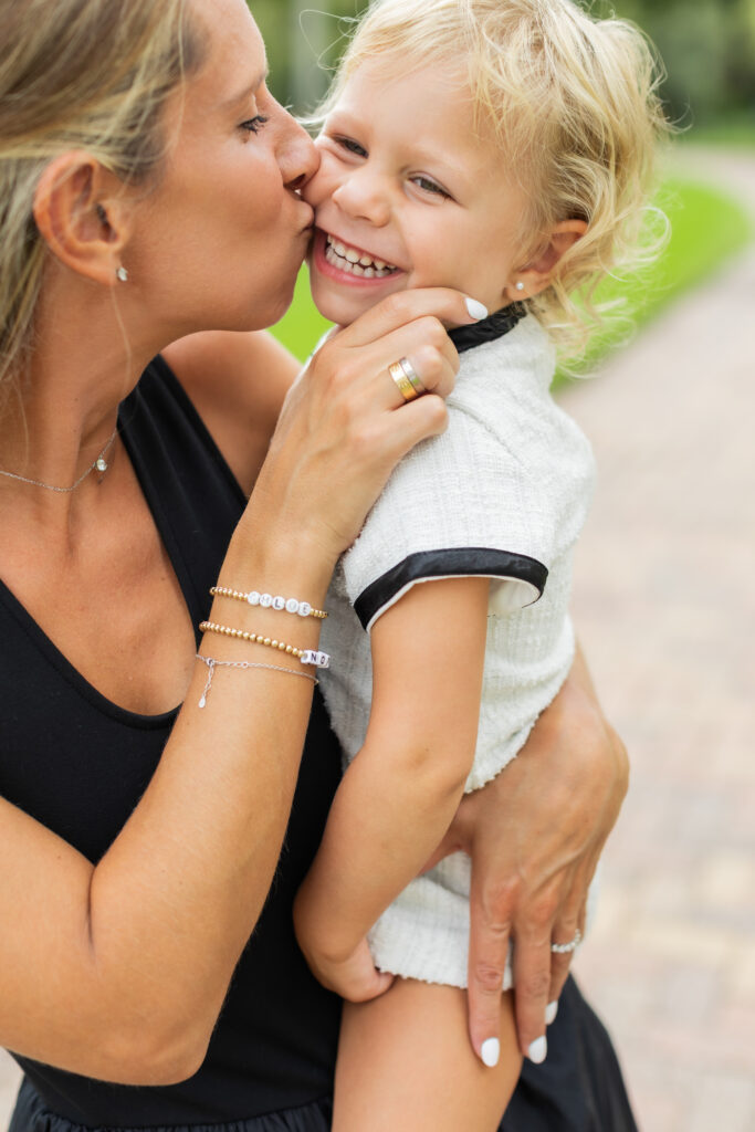 Mother holding daughter during family photo session in Palm Beach