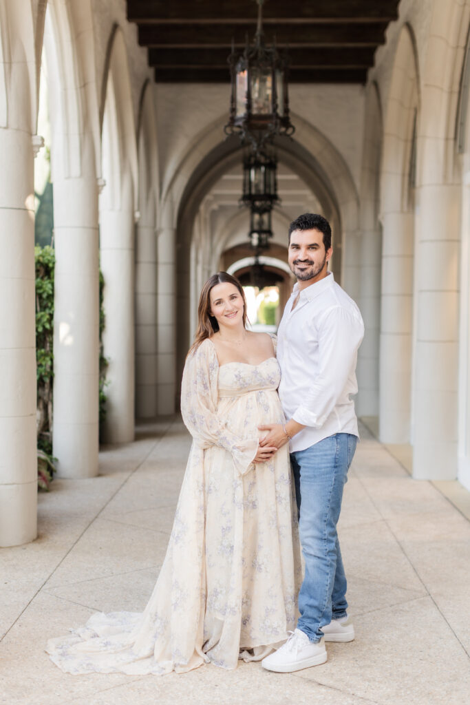 Expecting couple standing together on Worth Avenue during a Palm Beach maternity session
