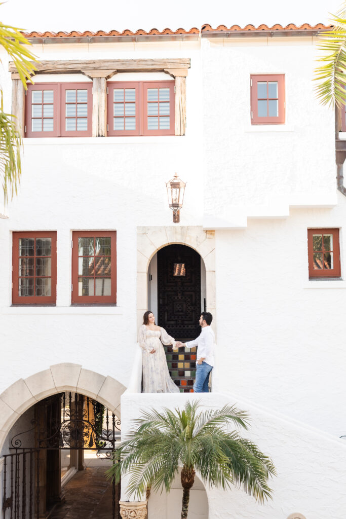 Expecting mother photographed in the elegant architecture of Worth Avenue during a Palm Beach maternity session