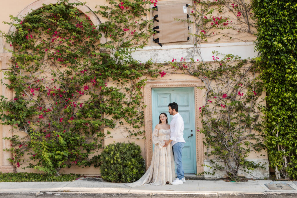 Maternity portrait of a pregnant woman and husband surrounded by the beautiful architectural details of Worth Avenue in Palm Beach, Florida