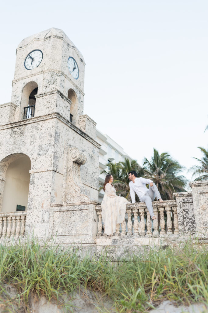 Expecting couple photographed together at the Palm Beach Clock Tower during their maternity session