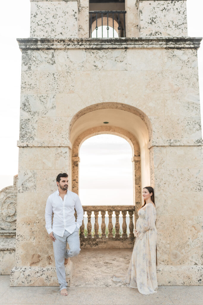 Romantic maternity portrait of an expecting couple by the Clock Tower in Palm Beach