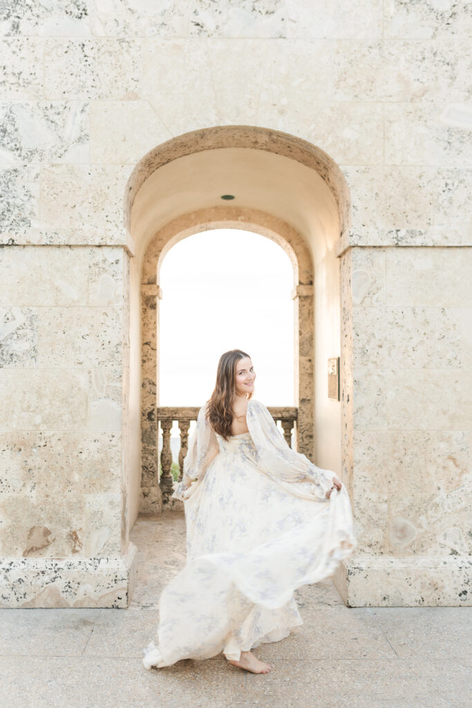Pregnant mother in a flowing gown during a sunrise maternity photoshoot in Palm Beach